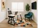 Bright home office with a modern desk, comfortable seating, and a colorful rug at 8550 Lost Pony St, Las Vegas, NV 89148