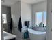 A modern bathroom with a standalone tub, large windows, and stylish finishes at 871 Buol Rd, Pahrump, NV 89048