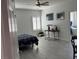 Bright bedroom features a ceiling fan, shuttered window, and ensuite bathroom at 871 Buol Rd, Pahrump, NV 89048