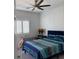 Cozy bedroom with blue bedding, shutters, and decorative bedside accents at 871 Buol Rd, Pahrump, NV 89048