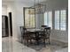 Cozy dining room with elegant chandelier, seating for four, and shutters at 871 Buol Rd, Pahrump, NV 89048
