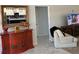Entryway with red credenza, white armchair, and view into the modern kitchen at 871 Buol Rd, Pahrump, NV 89048