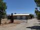 The home has a gated driveway, outbuildings, and mountain views in the distance at 871 Buol Rd, Pahrump, NV 89048