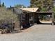 Exterior of the property highlighting a covered carport and ample outdoor workspace at 871 Buol Rd, Pahrump, NV 89048