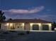 Lovely single-story home with a red tile roof, two-car garage, and desert landscaping at dusk at 871 Buol Rd, Pahrump, NV 89048
