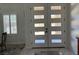 Modern front door with glass panels and views of a home interior with marble flooring at 871 Buol Rd, Pahrump, NV 89048