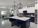 Modern kitchen featuring a large island with seating, stainless steel appliances, and stylish pendant lighting at 871 Buol Rd, Pahrump, NV 89048