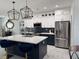 Stylish kitchen with modern island seating and stainless appliances overlooking the living room at 871 Buol Rd, Pahrump, NV 89048