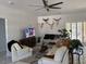 Bright living room featuring a ceiling fan, TV and decorative bull skulls above a couch at 871 Buol Rd, Pahrump, NV 89048