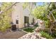 This private backyard features a desert landscape and mature trees at 9022 Sosa Creek Ave, Las Vegas, NV 89149