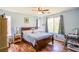 Serene bedroom with wood floors, light blue walls, and a large window at 9022 Sosa Creek Ave, Las Vegas, NV 89149