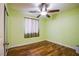 Bright bedroom featuring hardwood floors, a ceiling fan, and natural light from the window at 9022 Sosa Creek Ave, Las Vegas, NV 89149