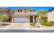 Charming two-story home featuring a well-manicured front yard and a spacious two-car garage at 9022 Sosa Creek Ave, Las Vegas, NV 89149