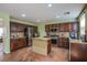 Well-equipped kitchen featuring stainless steel appliances, dark wood cabinetry, and a stylish kitchen island at 9022 Sosa Creek Ave, Las Vegas, NV 89149