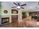 Open concept living area featuring hardwood floors, a fireplace, and views to the kitchen at 9022 Sosa Creek Ave, Las Vegas, NV 89149