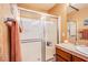 Bathroom shower featuring sliding glass doors, tile surround and built in soap shelves at 9022 Sosa Creek Ave, Las Vegas, NV 89149