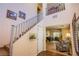 Interior view of the staircase featuring wood and tile and an overlook to the second floor at 9022 Sosa Creek Ave, Las Vegas, NV 89149