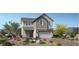 Two story home with attached garage, desert landscaping, neutral colors, and inviting curb appeal at 9027 Rolling Pietra St, Las Vegas, NV 89166