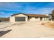 Single story home with a large driveway and attached two car garage at 9340 W Washburn Rd, Las Vegas, NV 89149