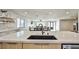 Modern kitchen island with quartz countertops and stainless steel appliances, open to the living space at 9340 W Washburn Rd, Las Vegas, NV 89149