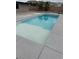 Backyard view of the refreshing pool with a tanning ledge and desert landscaping and mountain views at 9340 W Washburn Rd, Las Vegas, NV 89149