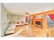 Comfortable living room with a hardwood floor and orange accent wall at 9879 Jazzy June St, Las Vegas, NV 89183