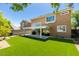 The backyard has artificial turf, a covered patio with seating, and views of the home at 1013 Corsica Ln, Las Vegas, NV 89144