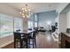 Bright dining area with a modern light fixture and an open floor plan, seamlessly flowing into the living space at 1013 Corsica Ln, Las Vegas, NV 89144