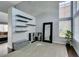 Spacious entryway with high ceilings, a decorative mirror, and modern shelving at 1013 Corsica Ln, Las Vegas, NV 89144
