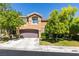 Two-story home with a well-manicured lawn and a two-car garage at 1013 Corsica Ln, Las Vegas, NV 89144