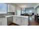Open-concept design, with stainless steel appliances and white cabinets, seamlessly connecting to dining and living spaces at 1013 Corsica Ln, Las Vegas, NV 89144