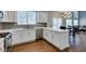Open kitchen showcasing stainless steel appliances, white cabinetry, and sightlines into dining and living areas at 1013 Corsica Ln, Las Vegas, NV 89144