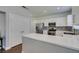 Modern kitchen featuring stainless steel appliances, white cabinets, stylish backsplash, and a spacious countertop at 1013 Corsica Ln, Las Vegas, NV 89144