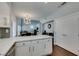 Modern kitchen with stainless appliances, white cabinets, and open design connecting to dining and living areas at 1013 Corsica Ln, Las Vegas, NV 89144