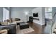 Bright living room featuring dark wood floors, modern fireplace, and large windows at 1013 Corsica Ln, Las Vegas, NV 89144