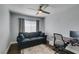 Comfortable living room with a gray sofa, desk, and a ceiling fan at 1013 Corsica Ln, Las Vegas, NV 89144