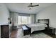 Main bedroom features a large window, ceiling fan, and dark wood furniture at 1013 Corsica Ln, Las Vegas, NV 89144