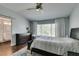 Main bedroom with a large bed, dresser, ceiling fan, and natural light at 1013 Corsica Ln, Las Vegas, NV 89144