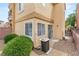 Small stone backyard area with exterior of home and shrubbery at 10437 Coyote Cub Ave, Las Vegas, NV 89129