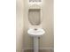 Bathroom featuring pedestal sink, mirror and tiled floors at 10437 Coyote Cub Ave, Las Vegas, NV 89129