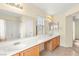 Bathroom with double sinks, a long mirror, and a shower-tub combo at 10437 Coyote Cub Ave, Las Vegas, NV 89129