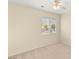 Bright bedroom featuring a ceiling fan and a window overlooking the neighborhood at 10437 Coyote Cub Ave, Las Vegas, NV 89129