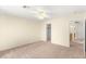 This bedroom features neutral carpeting, a ceiling fan, and direct access to an adjacent room at 10437 Coyote Cub Ave, Las Vegas, NV 89129