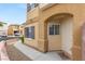 Inviting front entrance with a modern door and walkway, set against a charming exterior at 10437 Coyote Cub Ave, Las Vegas, NV 89129