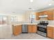 Bright kitchen with stainless steel appliances, light wood cabinets, and backyard access at 10437 Coyote Cub Ave, Las Vegas, NV 89129