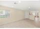 Spacious living room with tile floors, large windows, and neutral wall color at 10437 Coyote Cub Ave, Las Vegas, NV 89129