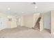 Spacious living room featuring tile floors, staircase, recessed lighting, and neutral color scheme at 10437 Coyote Cub Ave, Las Vegas, NV 89129