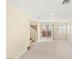 Bright living room with neutral walls and tile flooring, showing stairs leading to the second floor at 10437 Coyote Cub Ave, Las Vegas, NV 89129
