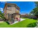Backyard featuring artificial grass, a patio, a pergola and a two-story house at 10645 Lace Vine Arbor Ave, Las Vegas, NV 89144