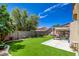 Backyard featuring manicured lawn, a patio, shade trees and privacy walls at 10645 Lace Vine Arbor Ave, Las Vegas, NV 89144